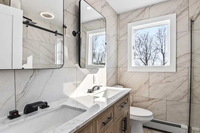 full bathroom with a sink, baseboard heating, a healthy amount of sunlight, and walk in shower