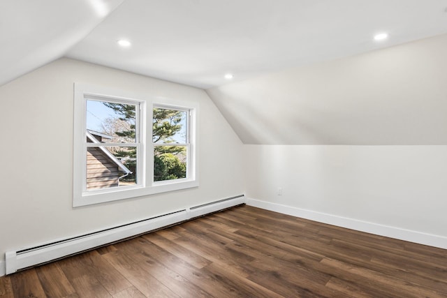 bonus room with baseboard heating, lofted ceiling, baseboards, and dark wood-style flooring