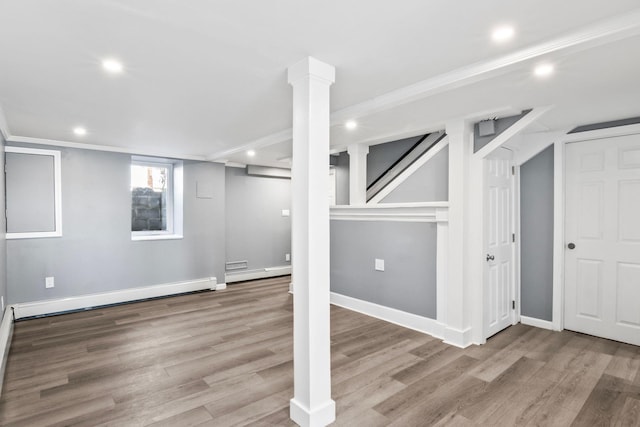 basement with recessed lighting, a baseboard radiator, wood finished floors, and a baseboard heating unit