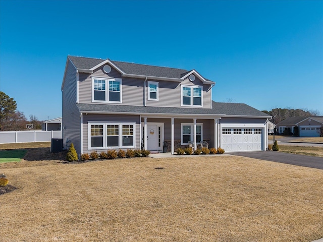 view of front of home featuring fence, aphalt driveway, central AC, a front yard, and an attached garage