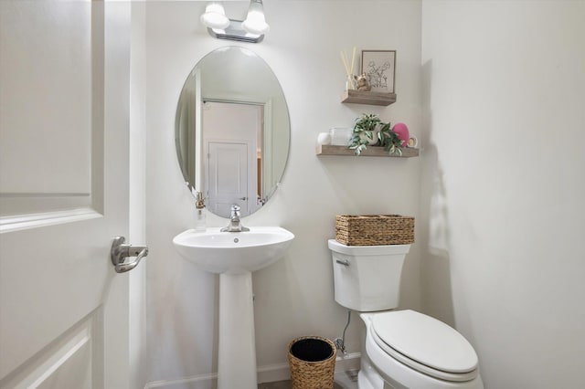 bathroom with toilet and a sink