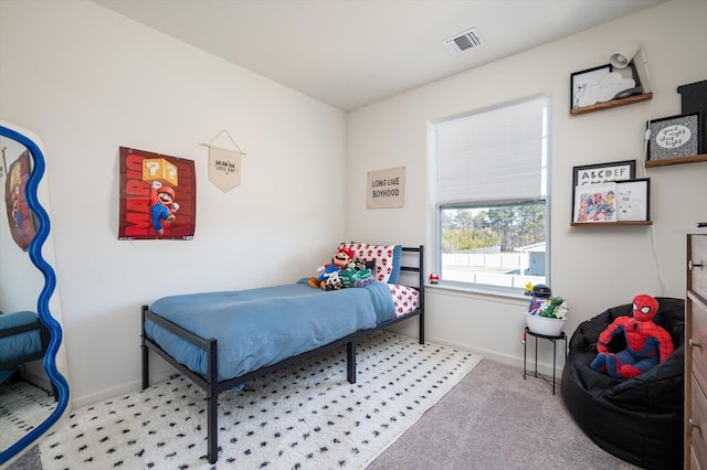 carpeted bedroom with baseboards and visible vents