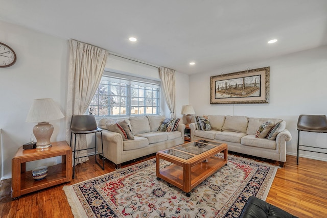 living area featuring recessed lighting, baseboards, and wood finished floors