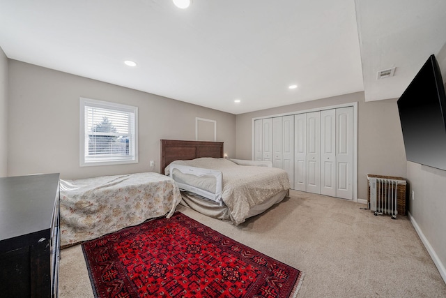 carpeted bedroom with baseboards, visible vents, radiator heating unit, recessed lighting, and a closet