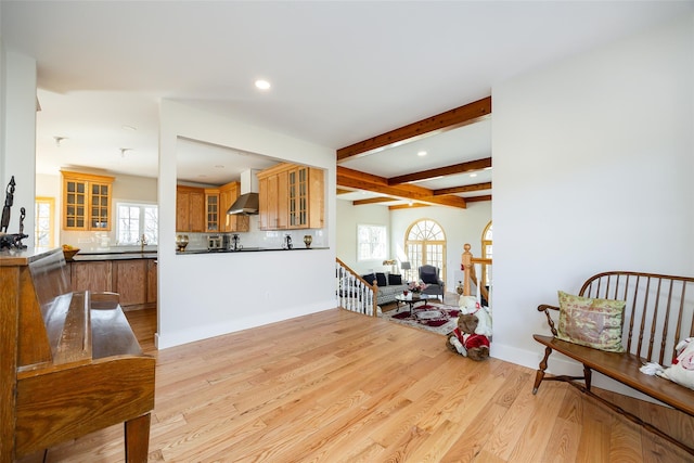 interior space with beamed ceiling, recessed lighting, baseboards, and light wood finished floors