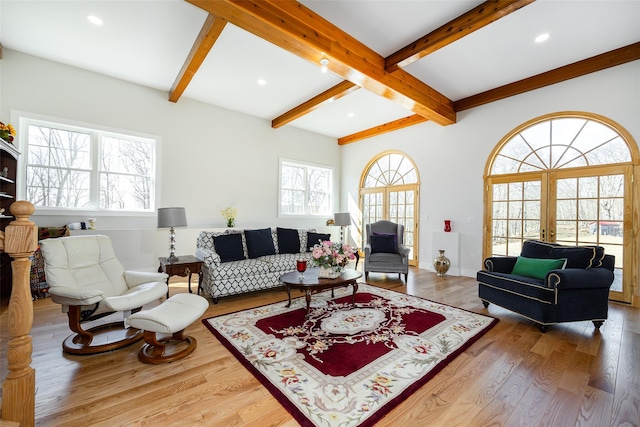 living room with beamed ceiling, recessed lighting, wood finished floors, and a healthy amount of sunlight