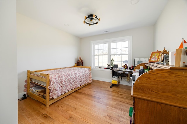 bedroom with visible vents and light wood-style floors