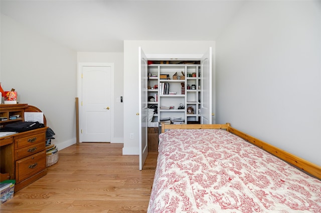 bedroom featuring baseboards and light wood-type flooring