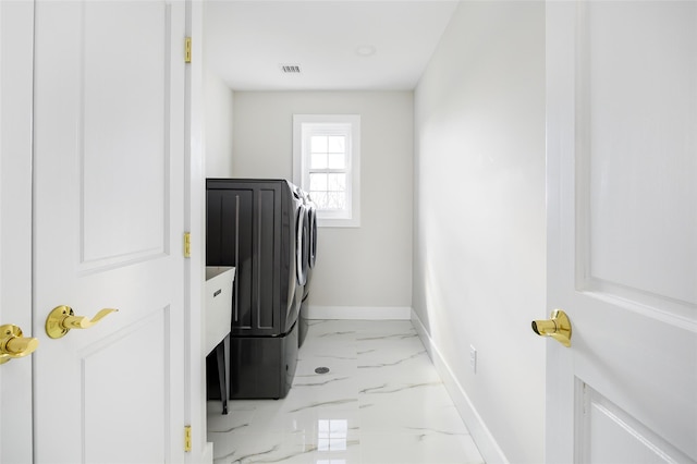 clothes washing area featuring baseboards, visible vents, laundry area, marble finish floor, and independent washer and dryer