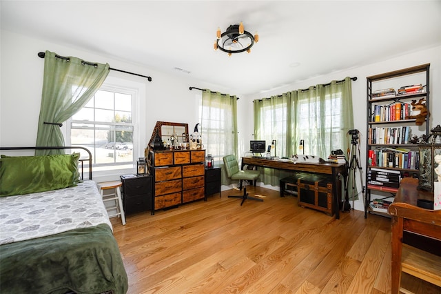 bedroom featuring light wood-type flooring and visible vents