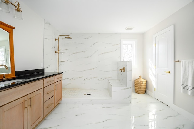 bathroom featuring a marble finish shower, visible vents, marble finish floor, and vanity