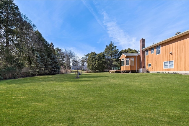 view of yard featuring an outdoor structure and central AC unit