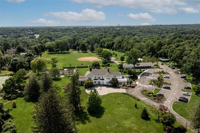 bird's eye view with a wooded view