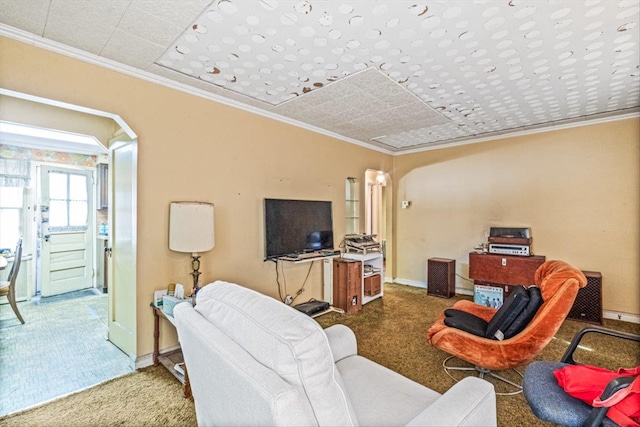 carpeted living area with baseboards, arched walkways, and ornamental molding