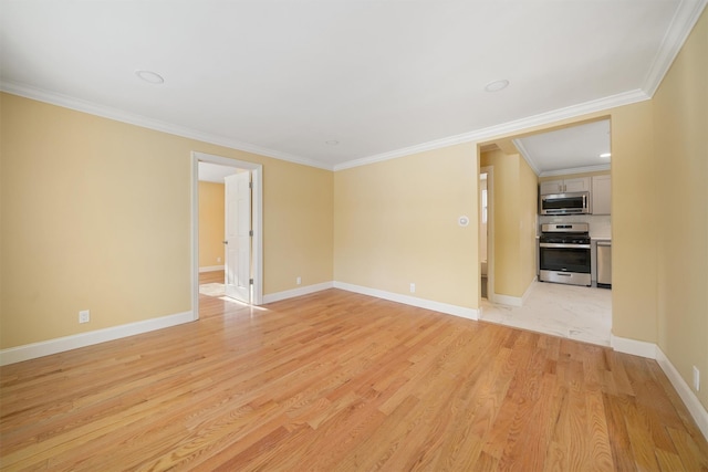 unfurnished room featuring baseboards, crown molding, and light wood finished floors