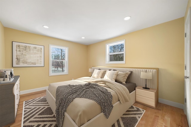 bedroom with recessed lighting, baseboards, and light wood-type flooring