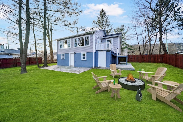 back of house with a patio, a fire pit, a fenced backyard, and stairs