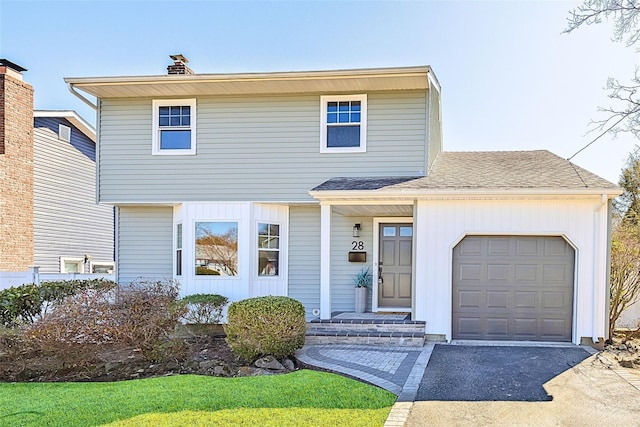 view of front of house with a garage, a chimney, driveway, and a shingled roof