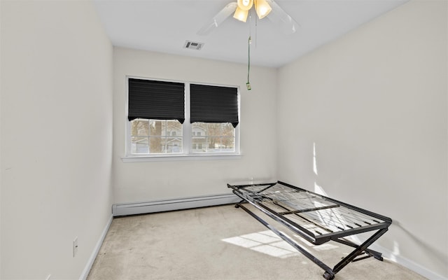 unfurnished room featuring a baseboard heating unit, a ceiling fan, visible vents, and carpet floors