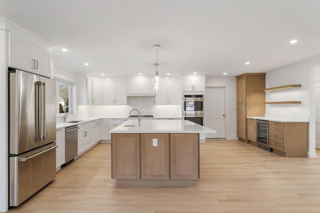 kitchen with a kitchen island with sink, a sink, open shelves, stainless steel appliances, and wine cooler