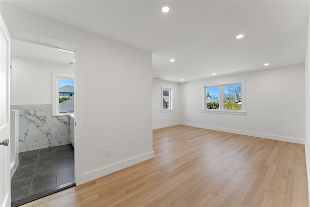 unfurnished room featuring recessed lighting, baseboards, and light wood-style floors