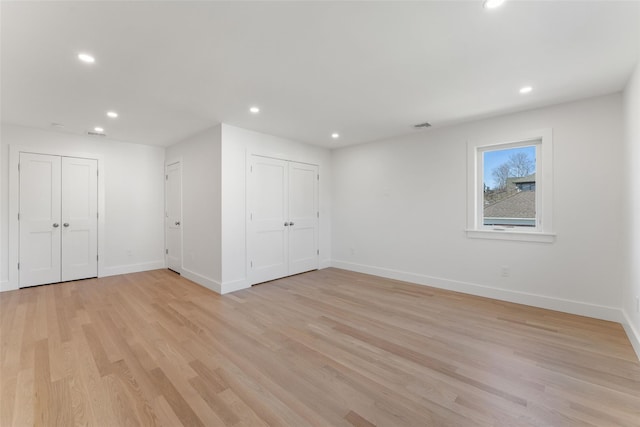 unfurnished bedroom with recessed lighting, baseboards, and light wood-style floors