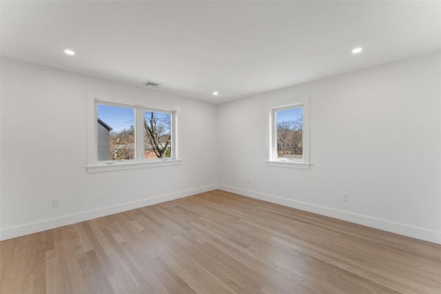 unfurnished room featuring recessed lighting, light wood-style flooring, and baseboards