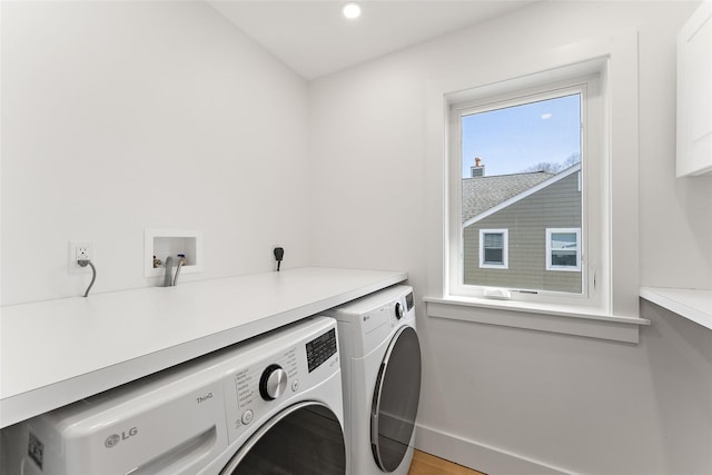 clothes washing area with recessed lighting, baseboards, washing machine and dryer, and laundry area