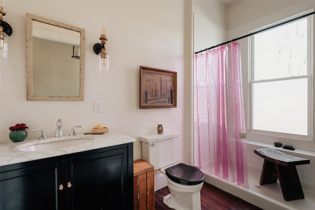 bathroom with vanity, curtained shower, toilet, and wood finished floors