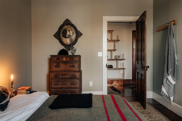 bedroom with wood finished floors and baseboards