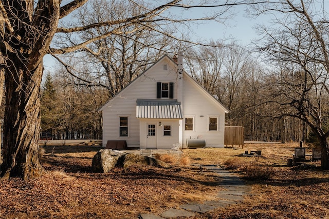 view of front of property featuring heating fuel and a chimney