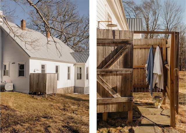 view of home's exterior with metal roof and heating fuel