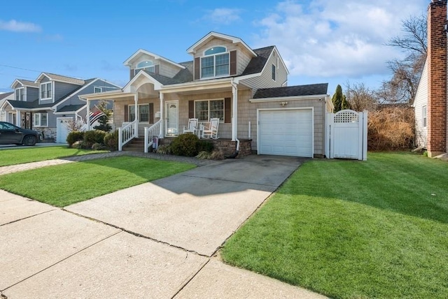 view of front of house with a front lawn, a gate, covered porch, concrete driveway, and an attached garage