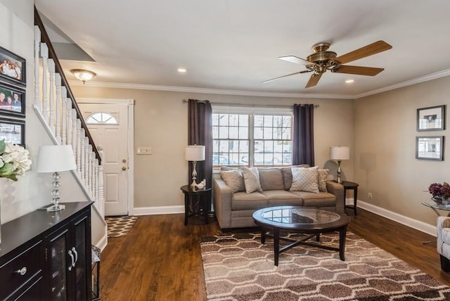 living area with baseboards, dark wood-type flooring, stairs, and crown molding