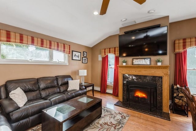 living room with a fireplace, wood finished floors, a ceiling fan, and vaulted ceiling