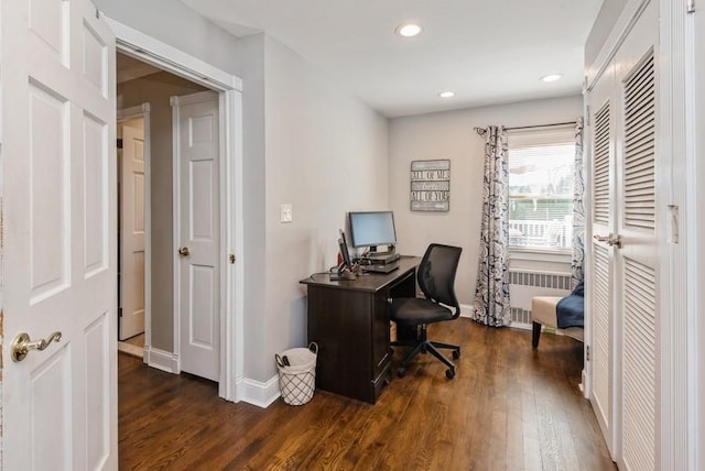 office space featuring dark wood finished floors, recessed lighting, radiator heating unit, and baseboards