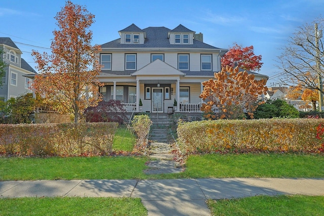 american foursquare style home featuring covered porch