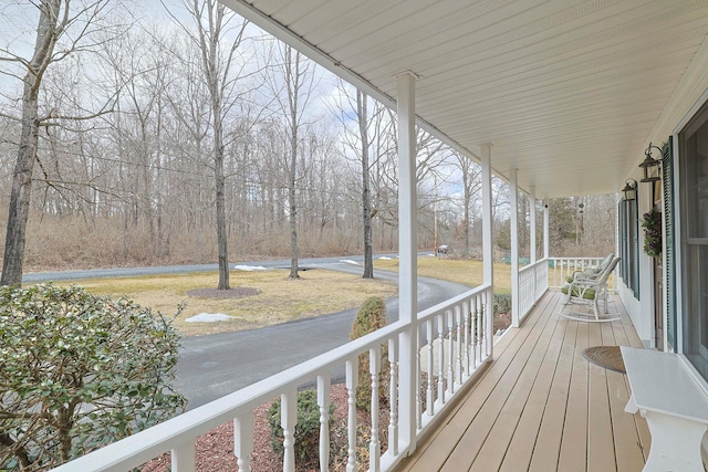 wooden terrace featuring covered porch