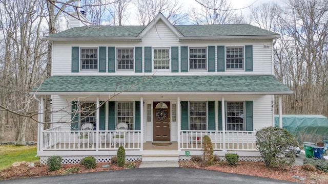 view of front facade with a porch and roof with shingles