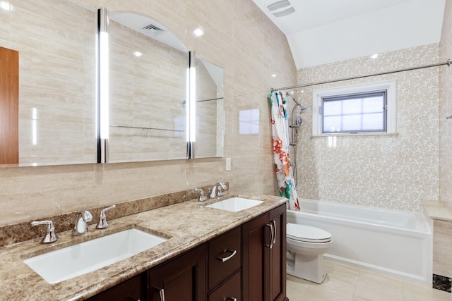 bathroom with a sink, visible vents, toilet, and tile walls