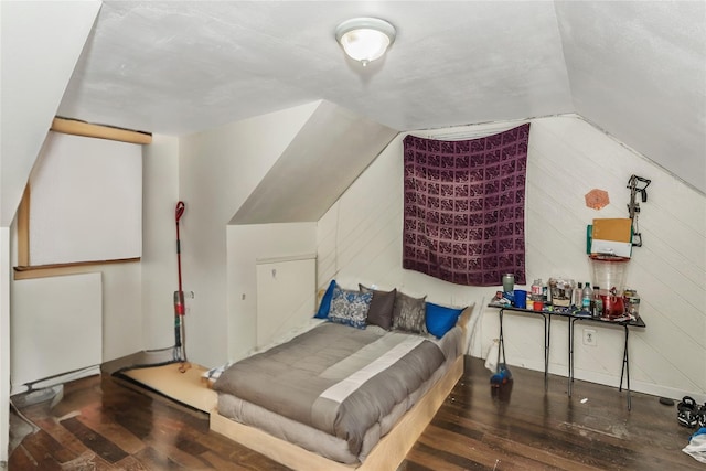 bedroom featuring vaulted ceiling and wood finished floors