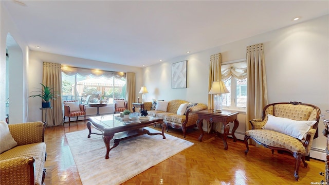 living area with recessed lighting, a baseboard radiator, and plenty of natural light