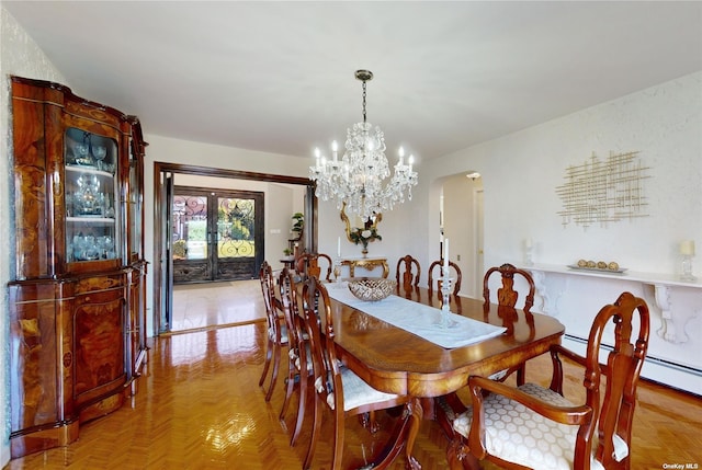 dining area with french doors, arched walkways, and a chandelier