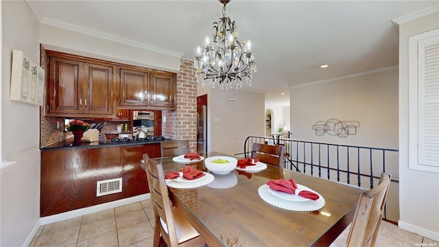 dining area featuring light tile patterned flooring, visible vents, and crown molding