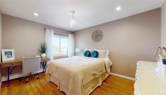 bedroom featuring light wood finished floors, recessed lighting, a baseboard heating unit, and baseboards