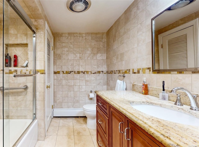 full bath with vanity, tile walls, toilet, and tile patterned floors