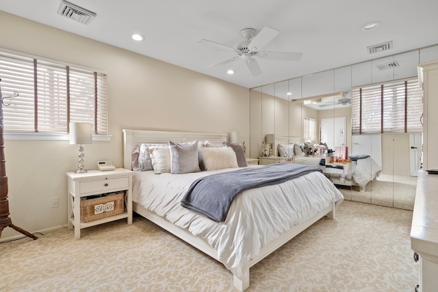 bedroom featuring recessed lighting, visible vents, and multiple windows