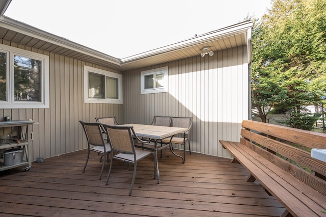 wooden terrace featuring outdoor dining area