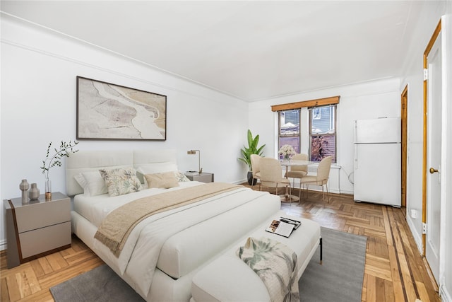 bedroom featuring freestanding refrigerator