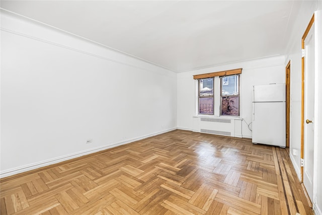 empty room with radiator and baseboards